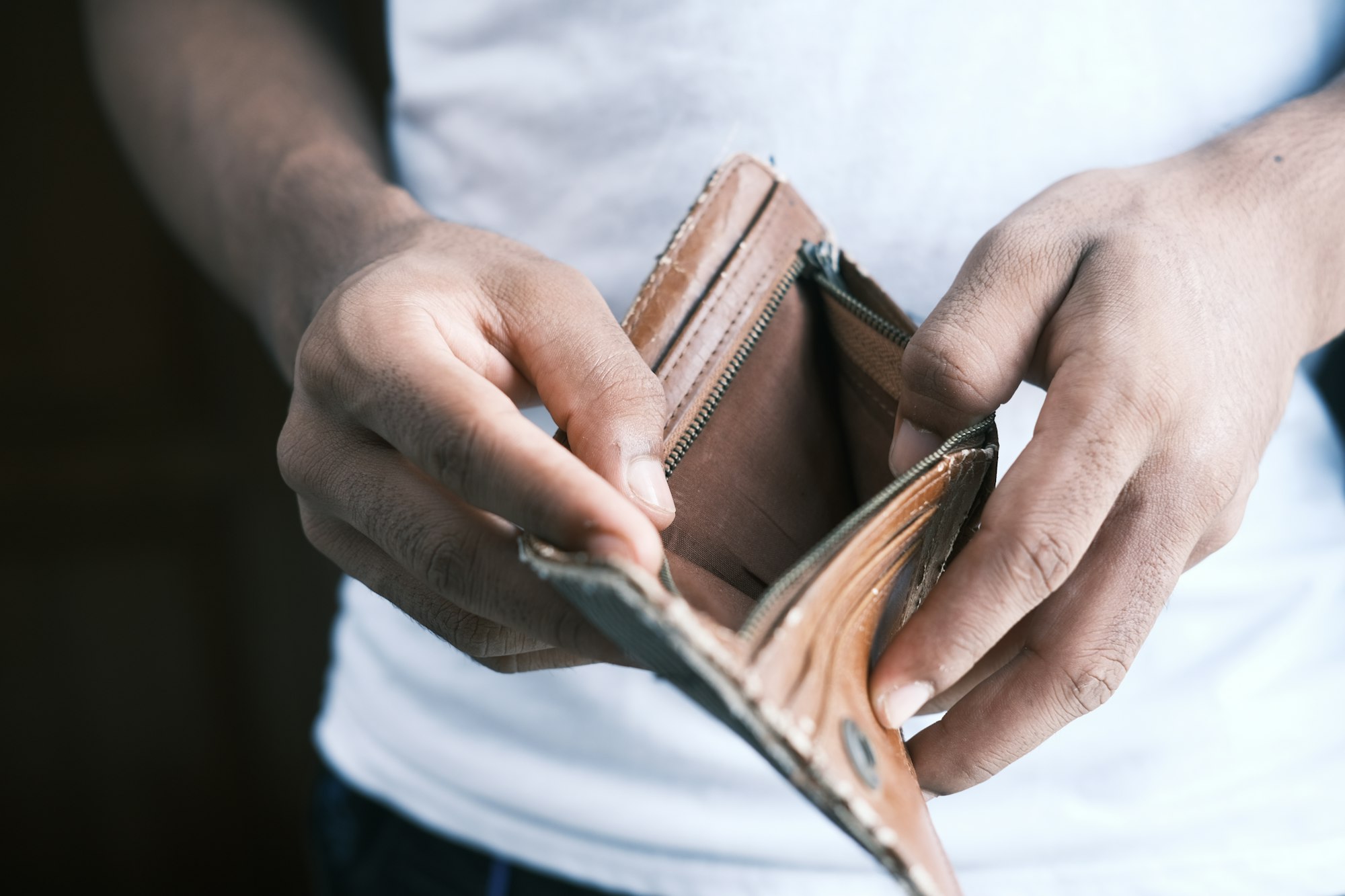 The Hidden Costs of Europe's Digital Gambling Explosion: Addiction, Exploitation, and the Quest for Reforms 34 | Mania Africa | maniainc.com A person holding an empty brown leather wallet | The Human Cost of Europe
