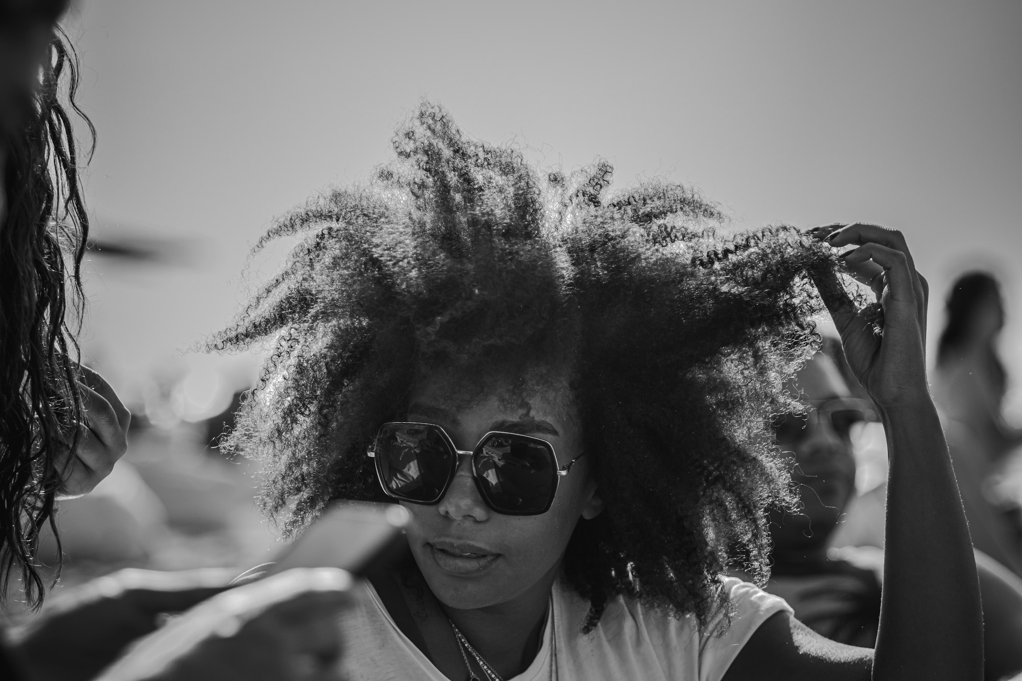 Taming Frizz: Your Ultimate Guide to Combatting Humid-Weather Hair 3 | Mania Africa | maniainc.com a woman with frizzy curly hair | Taming Frizz: Your Ultimate Guide to Combatting Humid-Weather Hair | Mania Beauty
