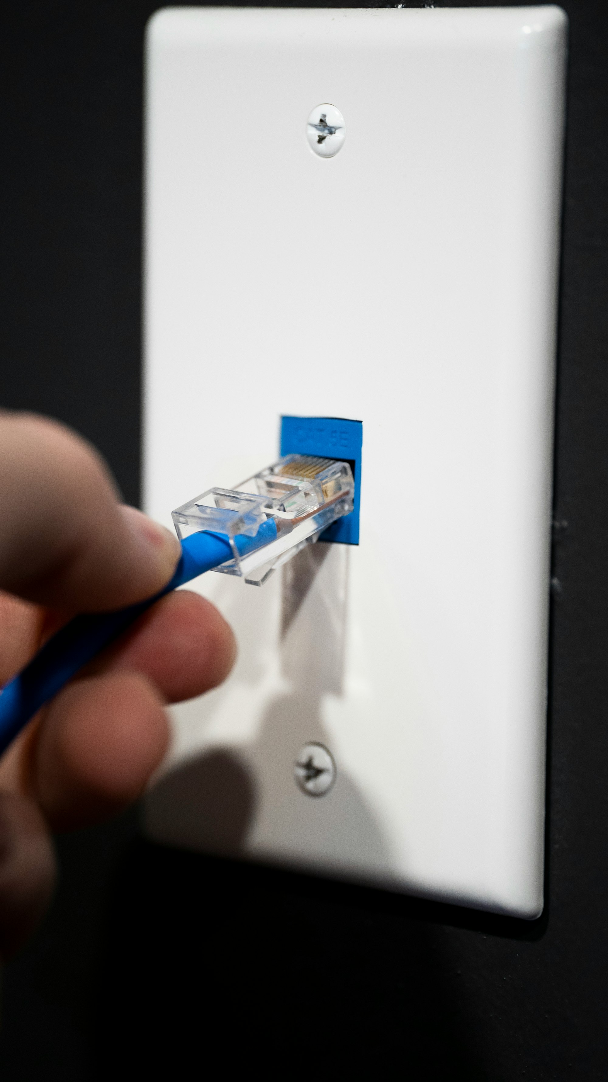 The Ultimate Guide to VPNs: Everything You Need to Know for Secure and Flexible Browsing 11 | Mania Africa | maniainc.com a person connecting an ethernet cable to a wall connector | How Do I Find the Best VPN for My Needs? | Comprehensive VPN Guide by Mania Africa