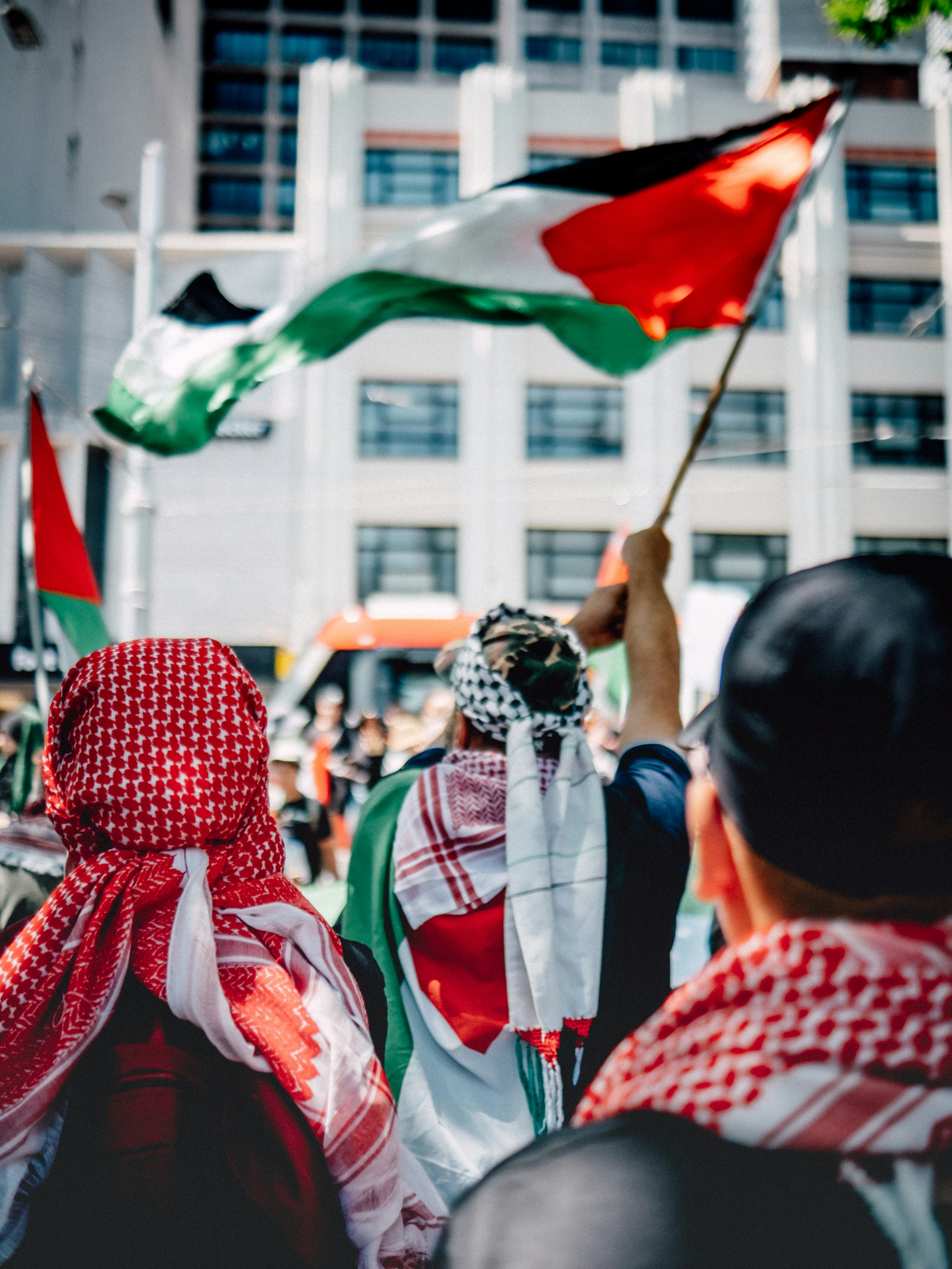 No Israel.. No More Violence.. Give Palestinians Their Country Back! 4 | Mania Africa | maniainc.com a group of people holding flags in front of a building