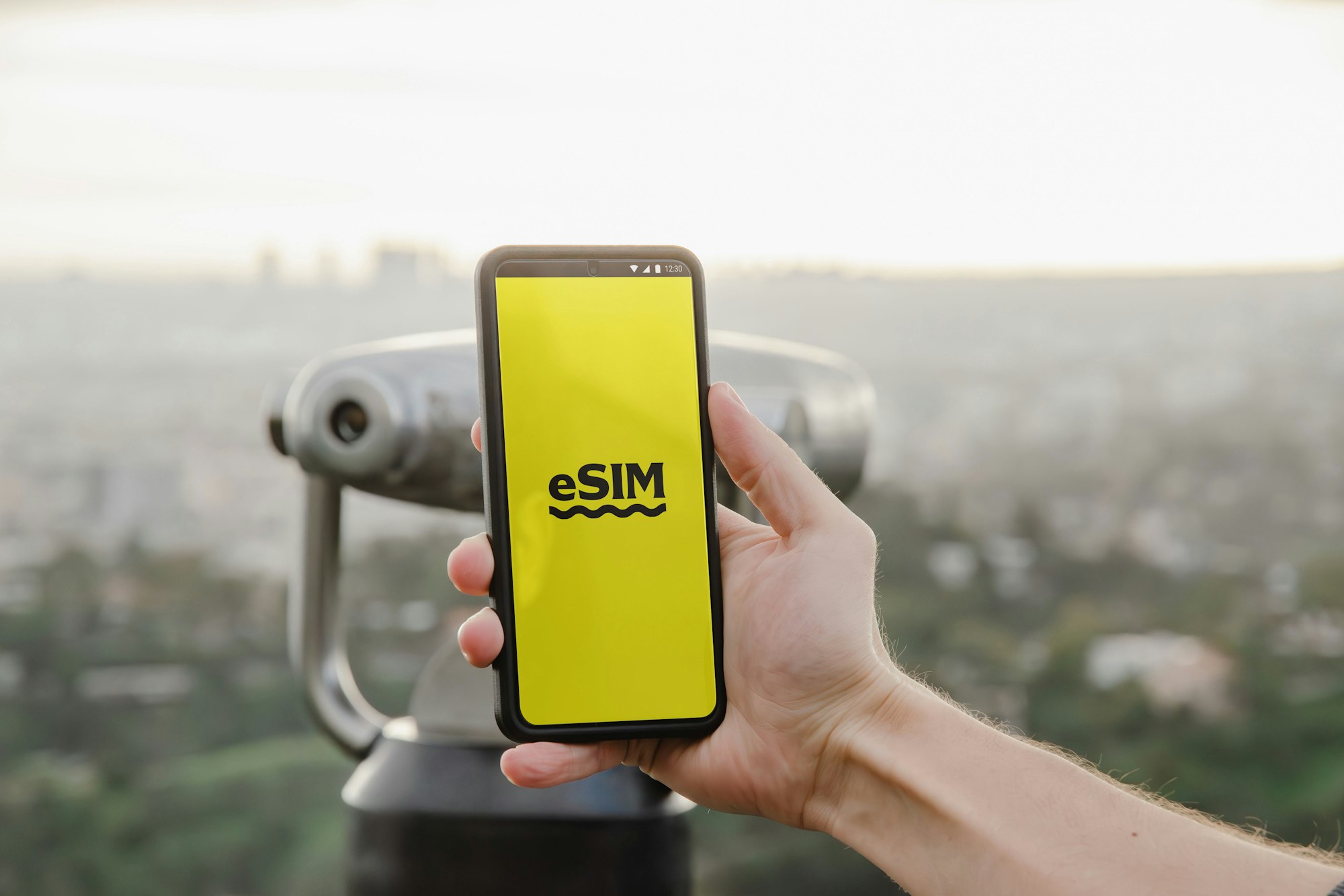 The Ultimate Guide to VPNs: Everything You Need to Know for Secure and Flexible Browsing 4 | Mania Africa | maniainc.com a person opening an eSIM app | How Can an eSIM Coupled with a VPN Bolster Digital Security? | Mania Guides