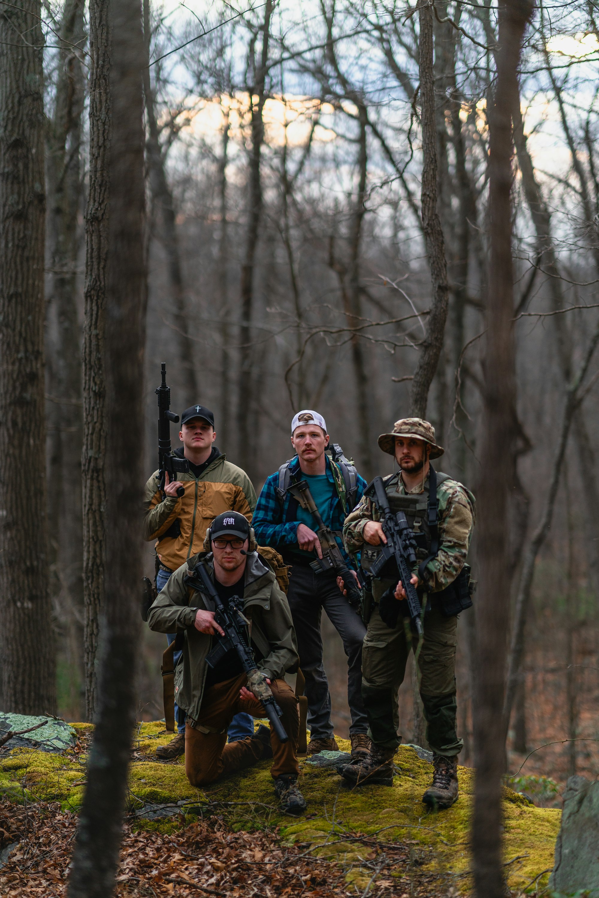 Conspiracy Theories and Extremism: Is a Civil War Looming in America? 17 | Mania Africa | maniainc.com a group of men standing next to each other in the woods