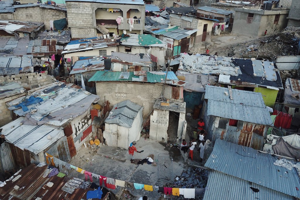 Gangs and Insecurity: Investigating the Root Causes of Instability in Haiti 3 | Mania Africa | maniainc.com A haiti settlement | Poverty and Its Enduring Impact on Haiti