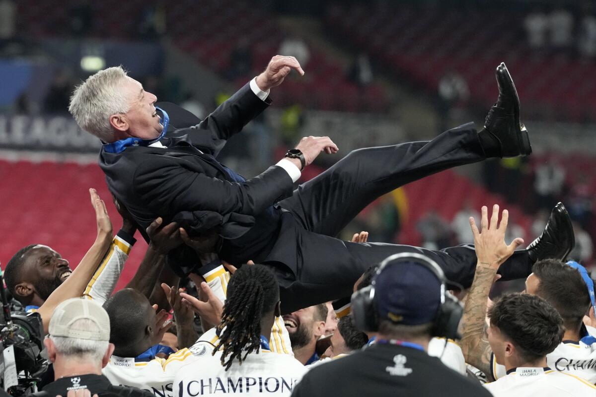 Real Madrid players celebrating their manager Carlo Ancelotti after they won the UCL 23-2024 Title | UCL Trophy | Mania Africa
