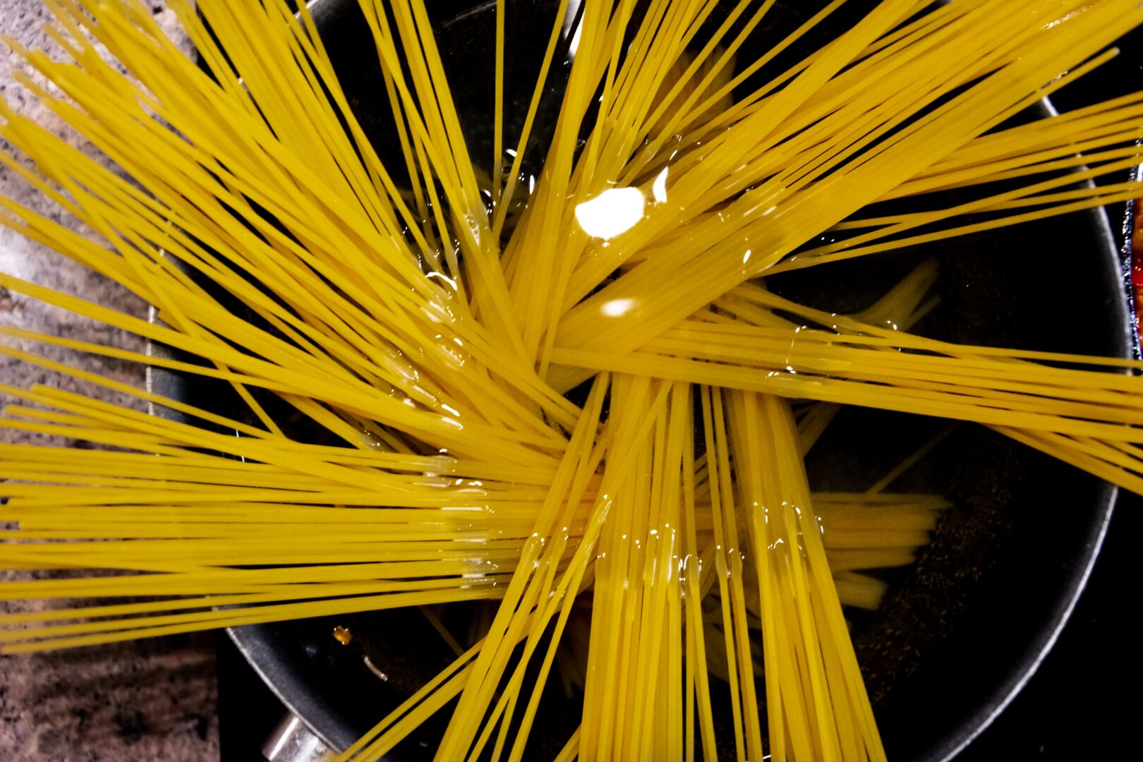 Untangling Clumped Up Spaghetti: A Step-by-Step Guide for Perfectly Separated Strands 6 | Mania Africa | maniainc.com yellow pasta on stainless steel bowl pre-cooking | Optimal Cooking Time for Perfectly Separated Pasta Strands