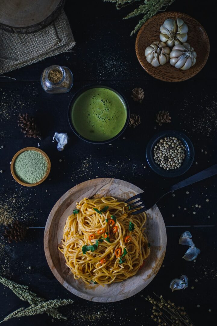 Untangling Clumped Up Spaghetti: A Step-by-Step Guide for Perfectly Separated Strands 5 | Mania Africa | maniainc.com pasta in bowl near bowl of green vegetables | Why Does Spaghetti Lump Up? | Mania Lifestyle