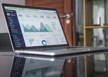 laptop computer on glass-top table - Maximize ROI for your SMB Website with Cloudways' CPU-Optimized Servers + Lightning Stack: Scale for Long-term Growth at an Affordable Price