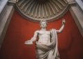 a statue of a Roman emperor holding a staff - Is Modern Society Addicted to Drama? What a TikTok Joke Reveals About the Brain, Addiction, & Our Hunger for Intensity - Mania Lifestyle