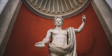 a statue of a Roman emperor holding a staff - Is Modern Society Addicted to Drama? What a TikTok Joke Reveals About the Brain, Addiction, & Our Hunger for Intensity - Mania Lifestyle